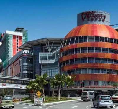 a building with a sign on top of it next to a street at Sunway Velocity link velo mall Muji-2BR \u4e2d\u6587\u623f\u4e1c in Kuala Lumpur