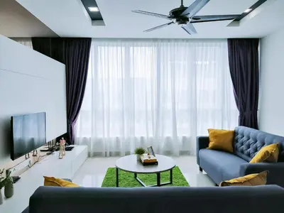 a living room with a blue couch and a table at Setapak Central Signature Suites by Manhattan Group in Kuala Lumpur
