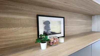 a shelf with a picture and a plant and a picture at Balcony Unit @ Robertson Residence 18f in Kuala Lumpur