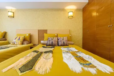 a large yellow bed in a room with two beds at Fahrenheit88 - Egypt Theme Kuala Lumpur Bukit Bintang in Kuala Lumpur