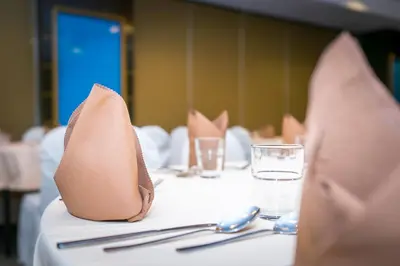 a table with napkins and utensils on top of a table at Crystal Crown Hotel Kuala Lumpur in Kuala Lumpur