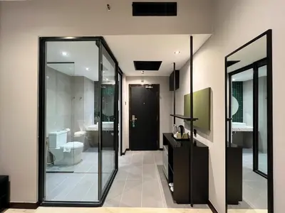 a bathroom with a toilet and a glass door at Crystal Crown Hotel Kuala Lumpur in Kuala Lumpur