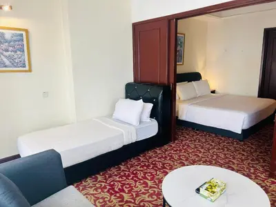 a hotel room with two beds and a couch at APARTMENT by Times Square KL in Kuala Lumpur