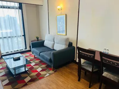 a living room with a couch and a table at APARTMENT by Times Square KL in Kuala Lumpur