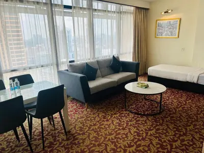 a living room with a couch and a bed at APARTMENT by Times Square KL in Kuala Lumpur