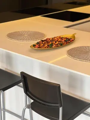 a plate of food on a counter with a chair at Star residance at Klcc - Two bedrooms with twin towers view in Kuala Lumpur