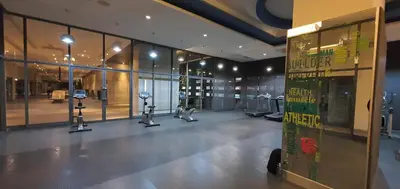 a gym with cardio equipment in a large building at The Elements Ampang Infinity Pool in Kuala Lumpur