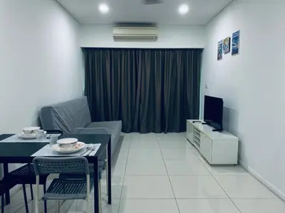 a living room with a couch and a table and a television at Summer Suites Apartment 7min walk to KLCC by GRIHOZ in Kuala Lumpur