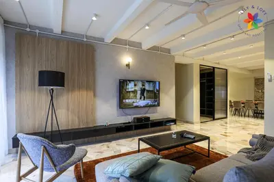 a living room with a couch and a tv on a wall at KL Townhouse Villa by LilyandLoft in Kuala Lumpur