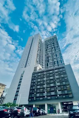 a tall building with cars parked in front of it at Chambers Couple studio Klcc in Kuala Lumpur