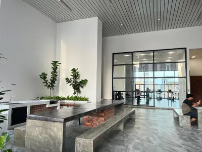 a lobby with a table and benches in a building at Chambers Couple studio Klcc in Kuala Lumpur