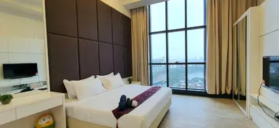 a hotel room with a bed and a large window at Panoramic KLCC Lake view, M CITY Jalan Ampang in Kuala Lumpur