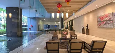 a lobby with a table and chairs in a building at Panoramic KLCC Lake view, M CITY Jalan Ampang in Kuala Lumpur