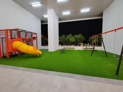 a room with a playground with a slide and swings at Chambers Residence by FANTASTIC in Kuala Lumpur
