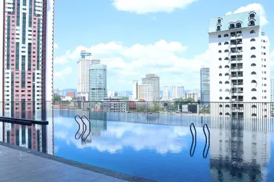 a pool of water with a city in the background at Chambers Residence by FANTASTIC in Kuala Lumpur