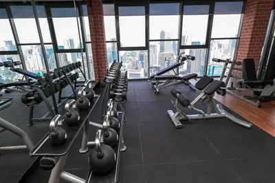 a gym with rows of exercise bikes and treadmills at Ceylonz Suites KLCC, Bkt Bintang in Kuala Lumpur