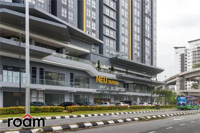 a new sites building with cars parked in front of it at Neu Suites Residence, Embassy Row in Kuala Lumpur