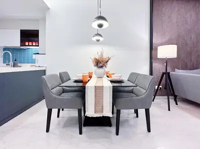 a dining room with a table and chairs at Tropicana The Residence Hermes Suite with KLCC View in Kuala Lumpur
