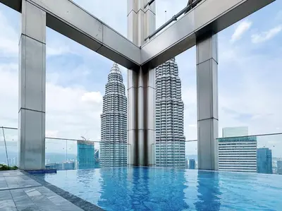 a pool on the top of a building with tall buildings at Tropicana The Residence Hermes Suite with KLCC View in Kuala Lumpur