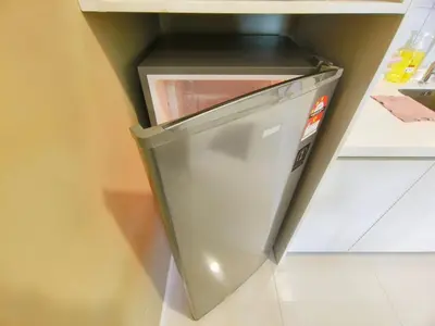 a refrigerator with its door open in a kitchen at Chambers Service Suites Amazing View KLCC in Kuala Lumpur