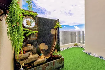 a miniature garden on a balcony with green grass at Penthouse Sky Jacuzzi At KLCC in Kuala Lumpur
