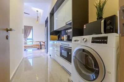 a kitchen with a washer and dryer in a room at Penthouse Sky Jacuzzi At KLCC in Kuala Lumpur