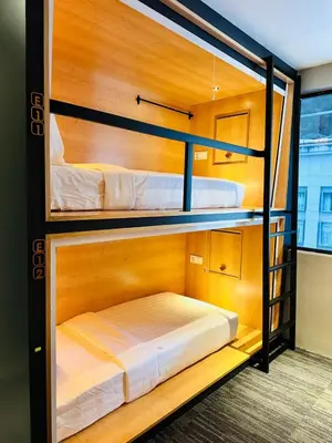 two bunk beds in a room with a bed in it at The Bed Bukit Bintang in Kuala Lumpur
