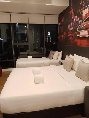 a hotel room with two large beds in a room at Ceylonz Suites By ANA MALAYSIA in Kuala Lumpur