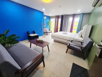 a living room with a couch and a bed at Boutique Hote123 in Kuala Lumpur