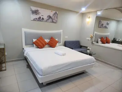a bedroom with a large white bed and a mirror at Boutique Hote123 in Kuala Lumpur