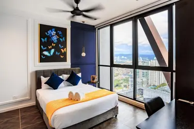 a bedroom with a large bed with a large window at Scarletz Suites KLCC by GC Luxury Suites in Kuala Lumpur
