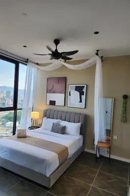a bedroom with a large bed with a ceiling fan at Scarletz Suites KLCC by GC Luxury Suites in Kuala Lumpur