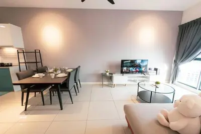 a living room with a table and a dining room at Continew Residence Cozy Suite by GUESTONIC in Kuala Lumpur