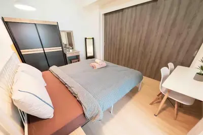 a bedroom with a bed and a table and chairs at Continew Residence Cozy Suite by GUESTONIC in Kuala Lumpur