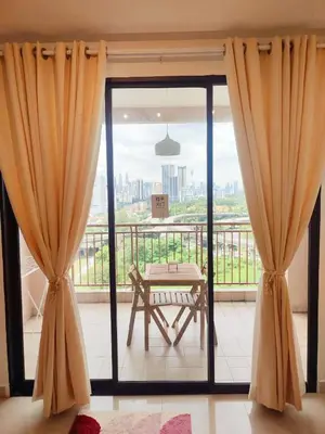 a room with a large glass door with a table on a balcony at KLCC Night View Spacious Muji MITEC 3min 121CAE in Kuala Lumpur