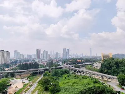 a view of a city with a highway and buildings at KLCC Night View Spacious Muji MITEC 3min 121CAE in Kuala Lumpur