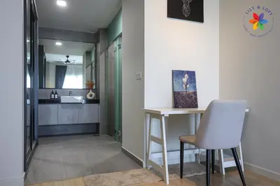 a small kitchen with a table and a chair at The Pano @ Jalan Ipoh by Lily and Loft in Kuala Lumpur