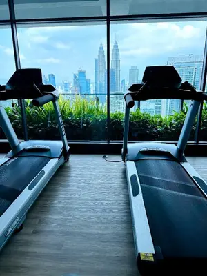 two exercise bikes in a room with a window at The Colony Stay Well studio with KL View in Kuala Lumpur