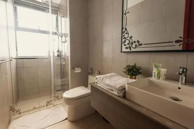 a bathroom with a sink and a toilet and a shower at Wizarding Residence near KLCC link LRT & Mall in Kuala Lumpur