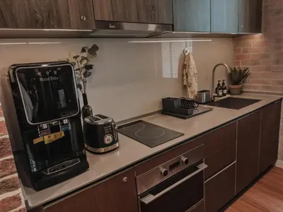 a kitchen with a counter with a phone on it at Wizarding Residence near KLCC link LRT & Mall in Kuala Lumpur