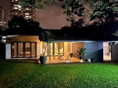 a house with a green lawn in front of it at Bungalow with Pool Karaoke PJ 12 in Petaling Jaya