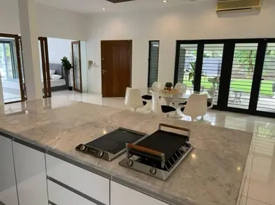 a kitchen with a counter top with a table and chairs at Bungalow with Pool Karaoke PJ 12 in Petaling Jaya