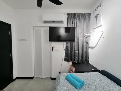 a living room with a tv on top of a refrigerator at Contemporary 2R2B Studio 10 minutes from KLCC in Kuala Lumpur