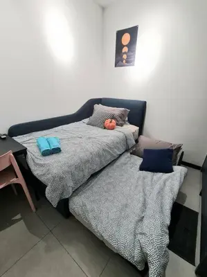 a bed with two pillows on it in a room at Contemporary 2R2B Studio 10 minutes from KLCC in Kuala Lumpur