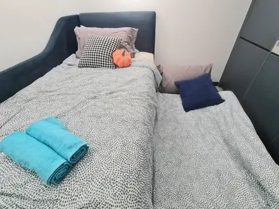 a bed with two pillows on top of it at Contemporary 2R2B Studio 10 minutes from KLCC in Kuala Lumpur