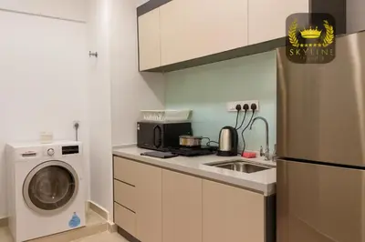 a kitchen with a sink and a washing machine at The Colony Skyline Suites KLCC in Kuala Lumpur