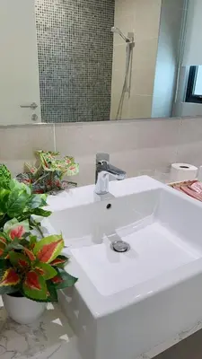 a white sink in a bathroom with a mirror at TheOoak suite 4pax cozy home stay @mont kiara in Kuala Lumpur