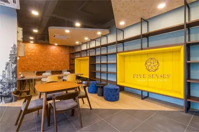an office with a yellow door and tables and chairs at Neu Suites Residence Kuala Lumpur, Roam in Kuala Lumpur