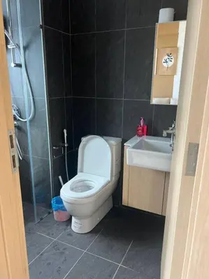 a bathroom with a toilet and a sink and a shower at Relax Bedroom Studio, The Luxe in Kuala Lumpur