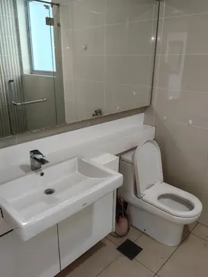 a bathroom with a sink and a toilet and a mirror at 5 Bukit Bintang 5 minutes to Alor Street Bukit Ceylon KLCC Pavilion Apt 3R2B 10 pax in Kuala Lumpur